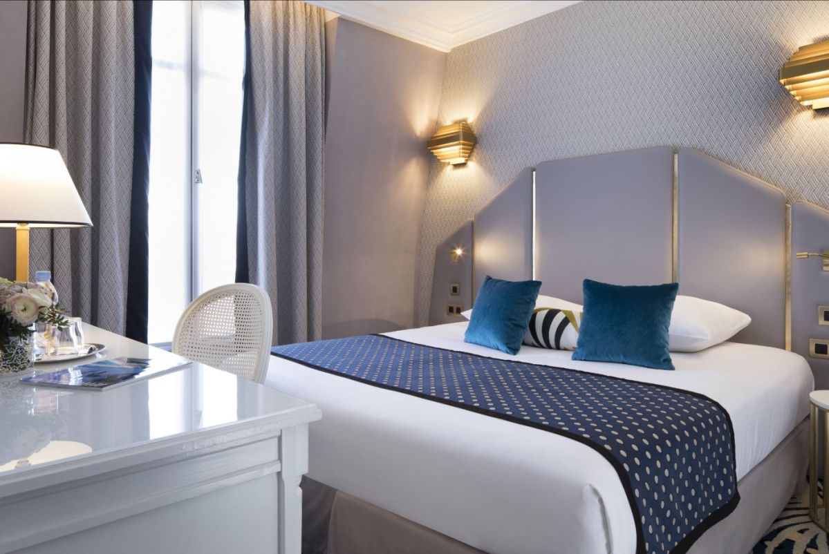 Classic Room at the Hôtel Victor Hugo with desk space, high-speed fiber Wi-Fi and Art-Deco decor for business & leisure travelers.